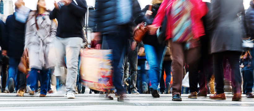 A crowd walks through the busy streets in Canberra.