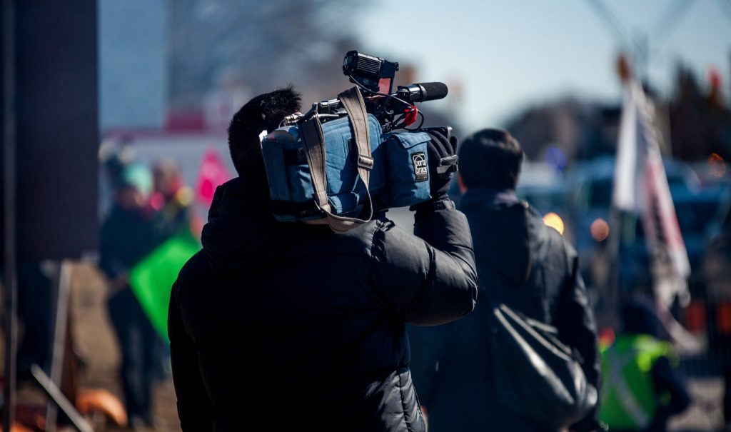 Cameraman with camera outside.