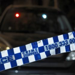 A car involved in a crime in Canberra is wrapped police tape.